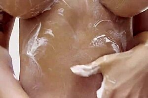 Monika Fox strips naked at home, smearing cream over big tits and butt in sensual posing. Watch her pierced nipples shine!