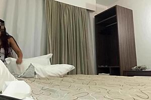 Sexy brunette teen maid arranges the hotel bed properly.