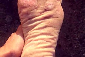 Dirty calloused soles on display