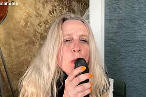 Housewife in latex corset fists herself outdoors