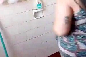 She does striptease in the bath, ripping clothes off her small tits for amateur fun.