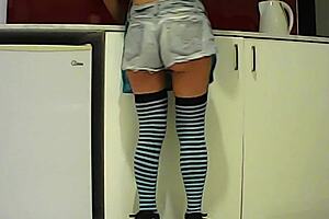 Watch this Latina babe eat a banana then suck a huge cock in the kitchen.