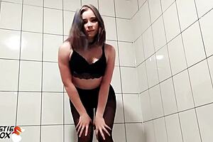 Young girl performs blowjob on muscular guy's cock in shower.