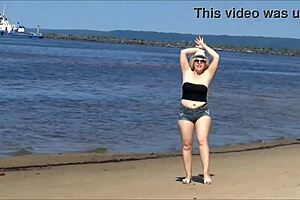 mature blonde milf struts big tits ass in tight jeans shorts on beach