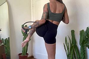 inked goth girl does rubber band yoga workout warm-up fitness tease