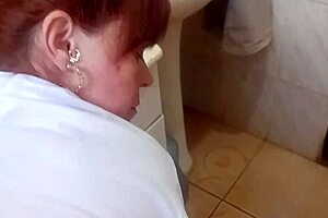 redhead spots her friend jerking in the shower and jumps in to lend a hand