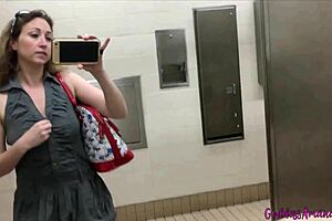 pretty girl shows off in bathroom mirror