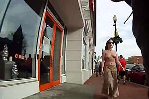 A girl walks topless around the town